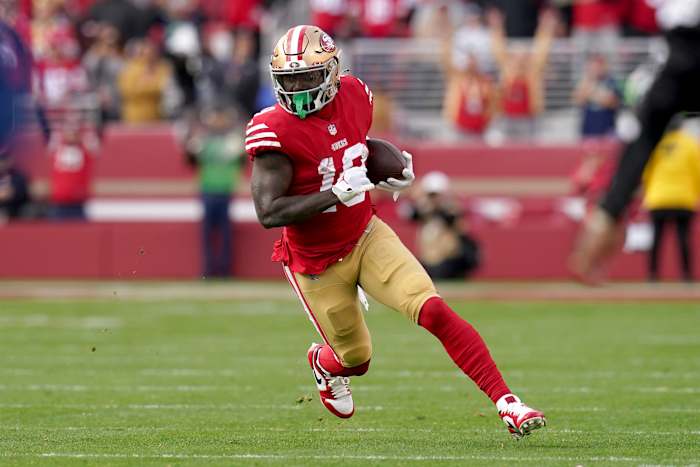 San Francisco 49ers wide receiver Deebo Samuel runs with the ball.
